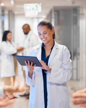Healthcare smiling at tablet