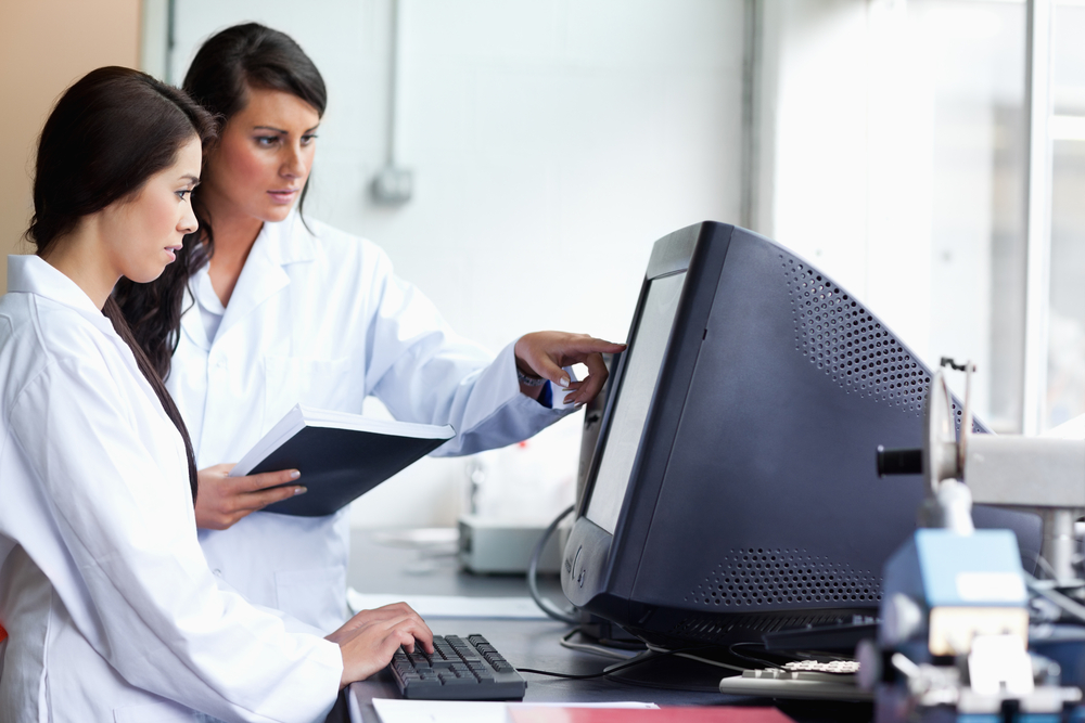 Female scientists looking at a monitor in a laboratory