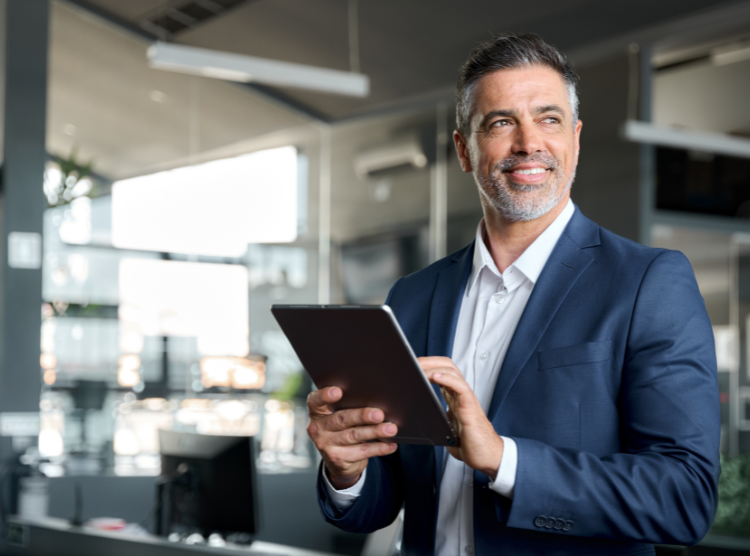 Smiling man holding a tablet